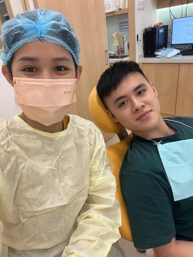 A patient with the A M Dental team after treatment